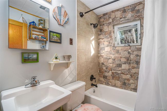 Bathroom featuring tile and stone, with upgraded fixtures | Image 13