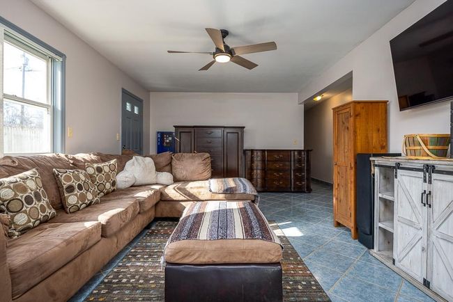 Family room has separate entrance and ceiling fan | Image 25