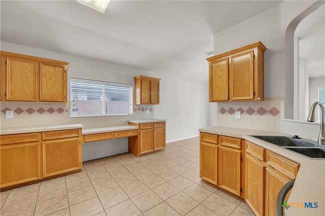 Kitchen open to living and dining ensures you never miss the action! | Image 8