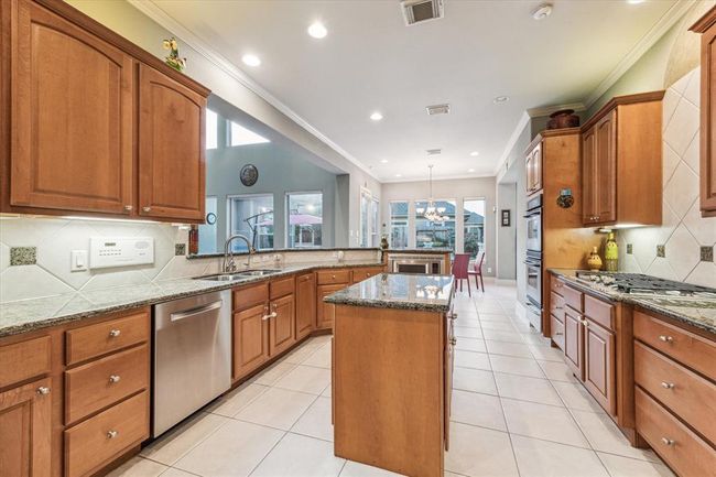 The Kitchen, the main hub of the home, shows off the ideal open concept allowing you not to miss a second of action. Look at all that counterspace! Kitchen also features a walk in pantry. | Image 11