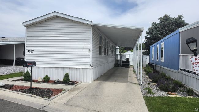 View of home's exterior featuring an attached carport and concrete driveway | Image 5