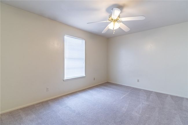 Unfurnished room featuring light carpet, baseboards, and a ceiling fan | Image 8