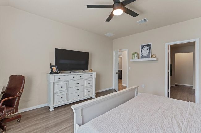 Bedroom featuring light wood finished floors and a ceiling fan | Image 15