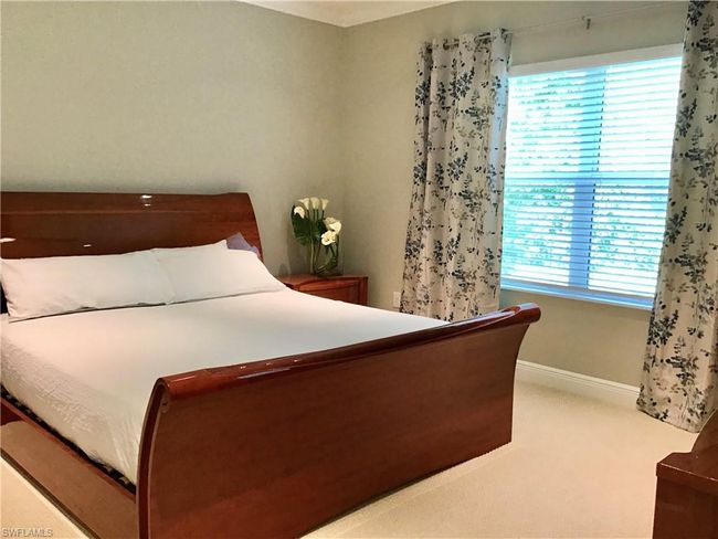 Primary bedroom with king size bed, TV, and two closets, one is a walk-in closet | Image 10