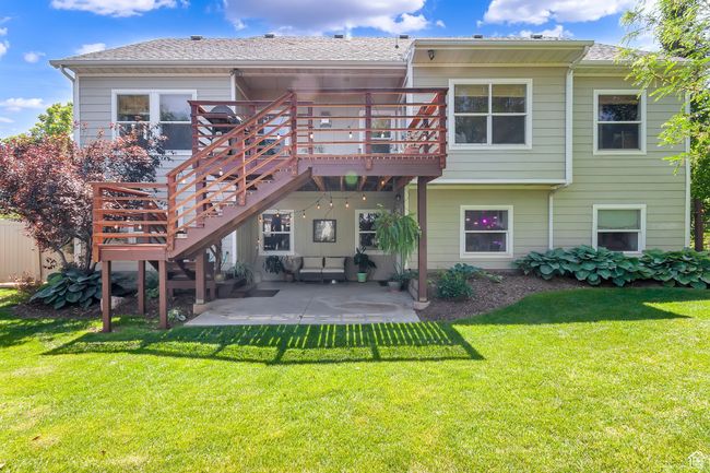 Rear view of house featuring a patio area, a deck, a yard, and stairway | Image 55