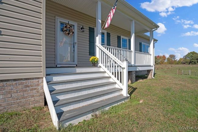 Doorway to property with a porch and a yard | Image 40