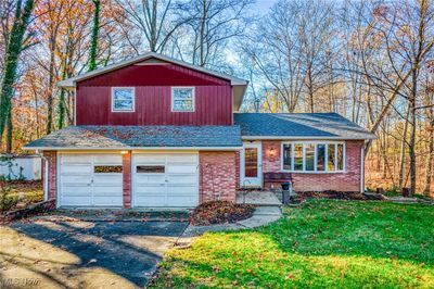 Split level home with a garage and a front yard | Image 1