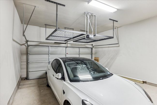 Garage featuring baseboards and a garage door opener | Image 31