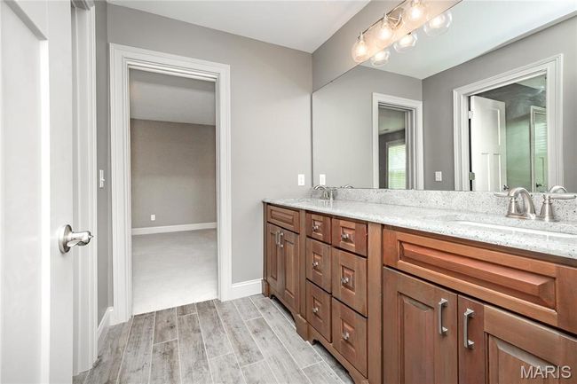 Full bathroom with baseboards, wood finished floors, double vanity | Image 38