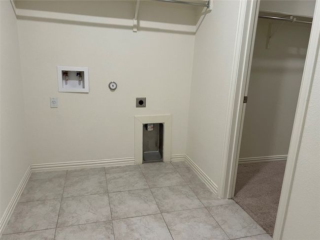 Laundry area on the main floor - connects to primary bedroom walk in closet.. | Image 20