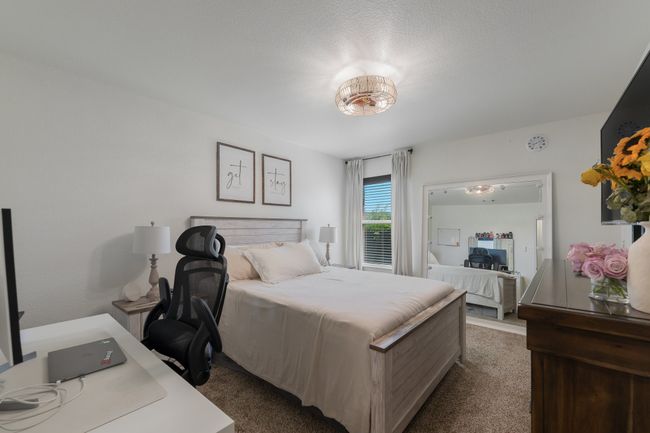 Carpeted bedroom with an office area | Image 24