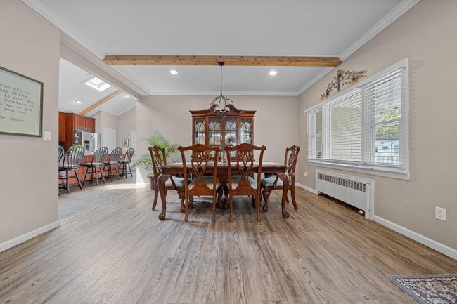 Kitchen with a sink, a kitchen breakfast bar, stainless steel appliances, decorative backsplash, and a kitchen island | Image 16