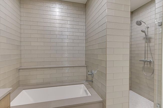 Bathroom with tiled shower and a bathtub | Image 10