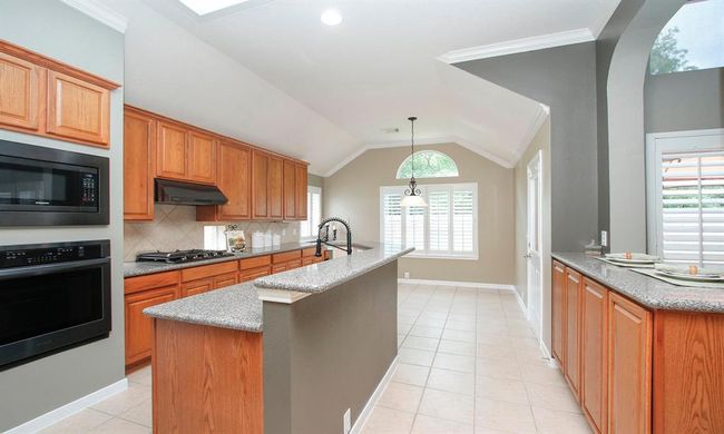 Cooking while entertaining guests is easily accomplished in this open and versatile kitchen! View overlooking the breakfast area. | Image 13