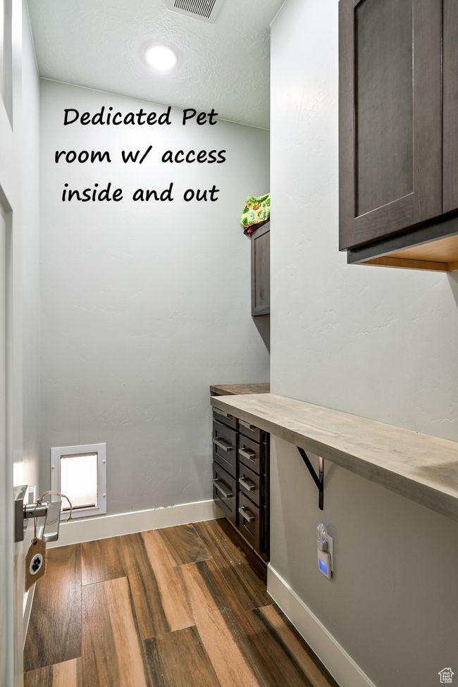Washroom with dark wood-type flooring and baseboards | Image 58
