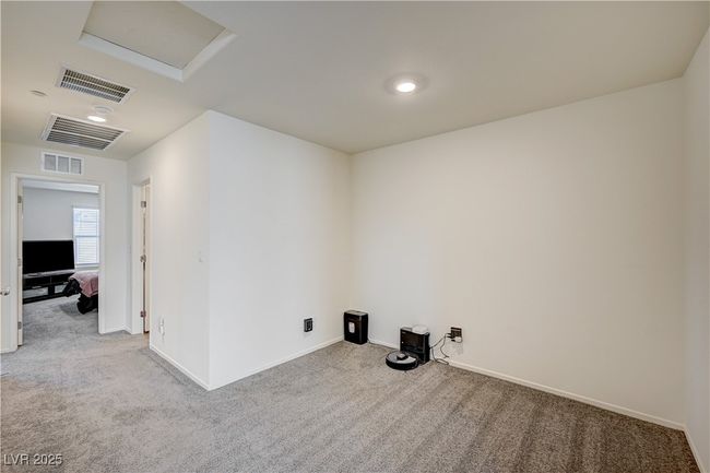 Carpeted spare room featuring attic access and baseboards | Image 8