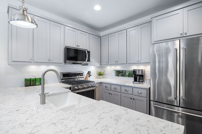Plenty of counter space. Recessed lighting and a modern window. | Image 23
