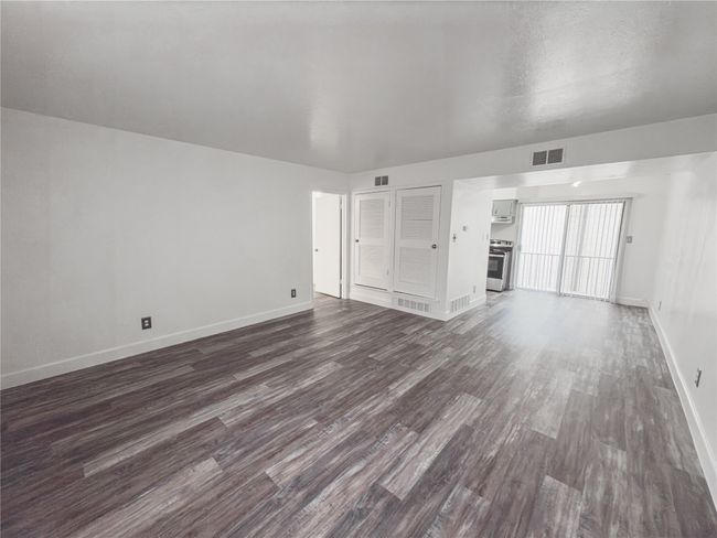 Unfurnished living room featuring dark hardwood / wood-style floors | Image 4