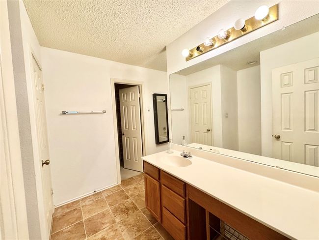 Bathroom featuring vanity and a textured ceiling | Image 15