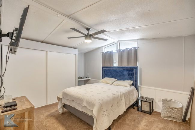 Carpeted bedroom with vaulted ceiling and a ceiling fan | Image 14