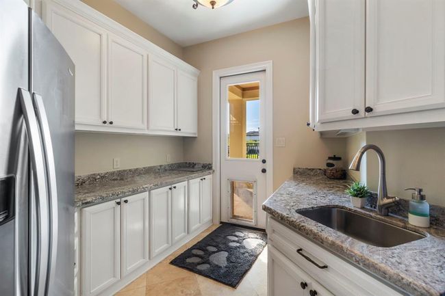 Spacious Laundry Room with Direct Access to Outdoor Dog Run. | Image 9