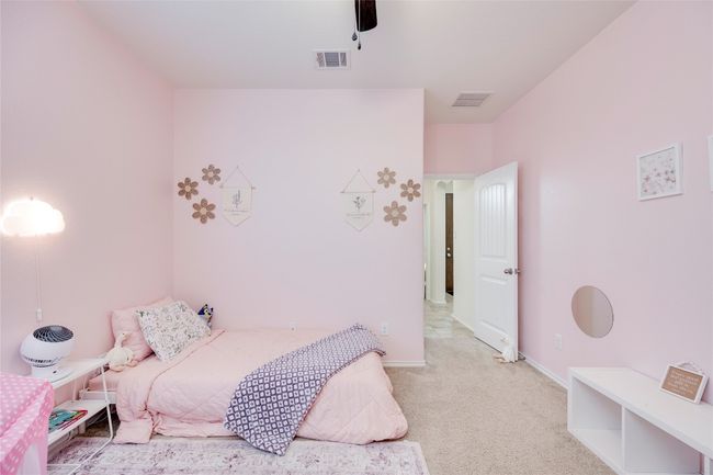 Bedroom with light carpet and a ceiling fan | Image 23