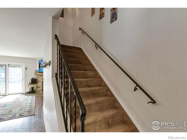 The gorgeous wrought iron handrails on the staircase leading to upper level adds additional character to the home. | Image 30