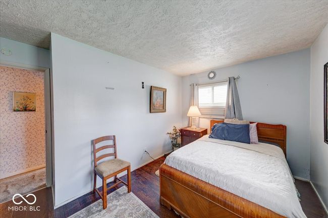 bedroom #2 with a textured ceiling, nice natural lighting, and wood finished floors | Image 31