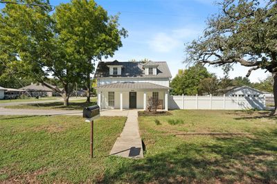 View of front of house with a front yard and a porch | Image 1