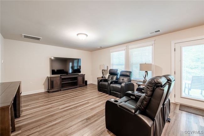 Living room featuring light wood-type flooring and plenty of natural light | Image 33