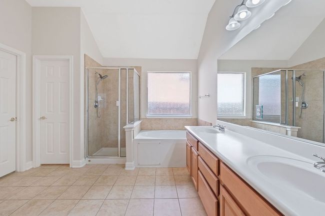 Full bathroom with a sink, vaulted ceiling, and a shower stall | Image 24