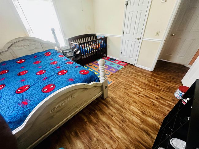 Bedroom featuring baseboards and wood finished floors | Image 13