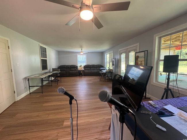 Living room featuring wood finished floors, ceiling fan, and baseboards | Image 18