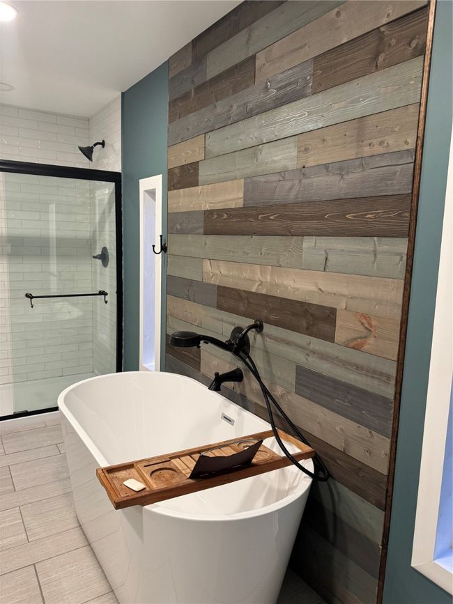 Full bathroom with a freestanding tub, wood walls, and wood finish floors | Image 14