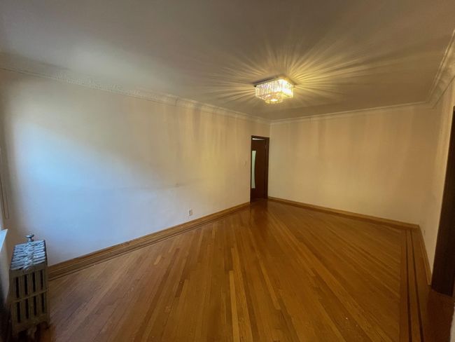 Unfurnished room with baseboards, ornamental molding, and wood finished floors | Image 8