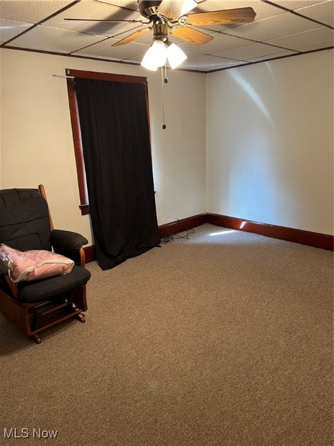 Unfurnished room with carpet floors, a paneled ceiling, and ceiling fan | Image 8