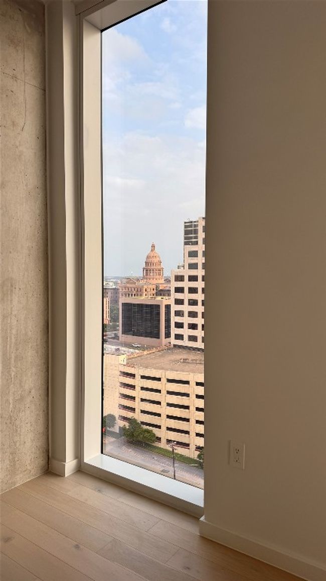 Unfurnished room featuring wood finished floors and a city view | Image 11