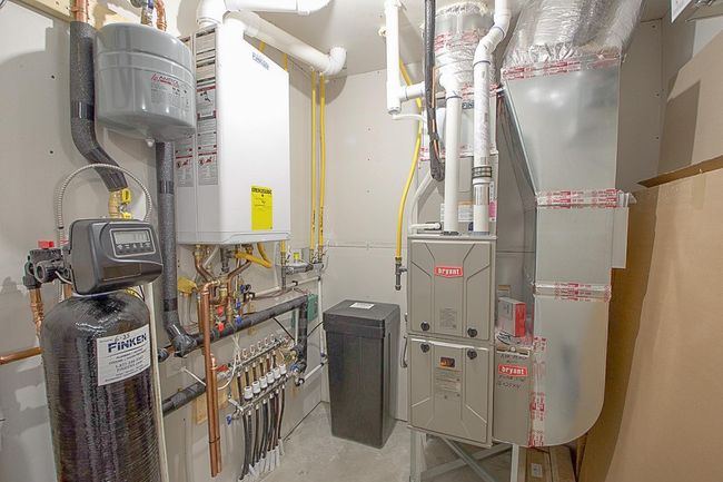 Zoned In floor heat, air exchanger, and tankless water heater with water softener for comfortable living | Image 22