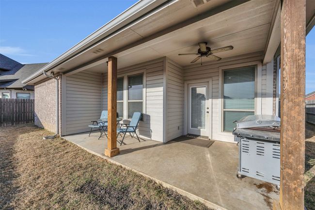 View of patio with a ceiling fan and fence | Image 27