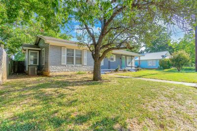 Ranch-style house featuring central AC and a front lawn | Image 1