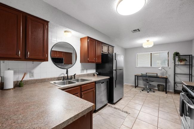 Kitchen with stainless steel appliances and breakfast area | Image 9