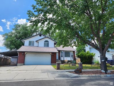 Tri-level home featuring a garage and a carport | Image 2