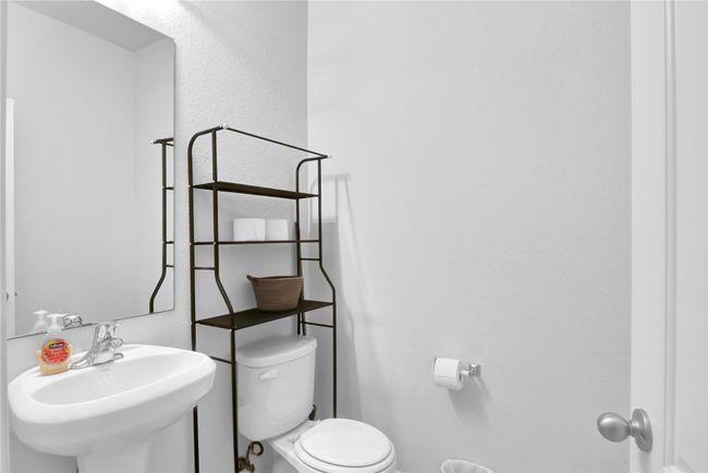 Bathroom with toilet and a sink | Image 5