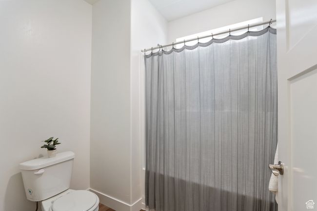 Full bathroom featuring toilet and shower / bath combo with shower curtain | Image 14