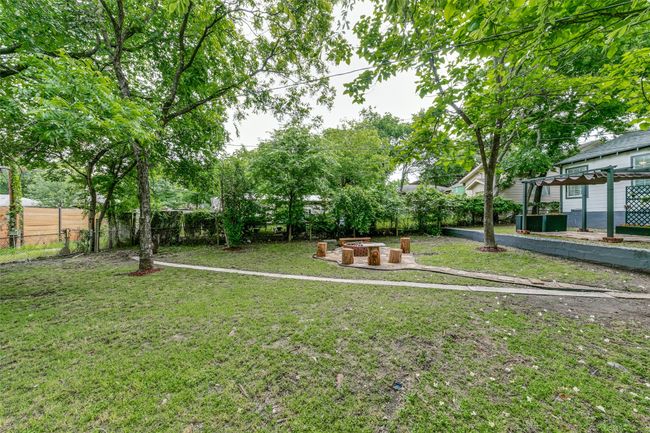 Fenced backyard with an outdoor fire pit | Image 24