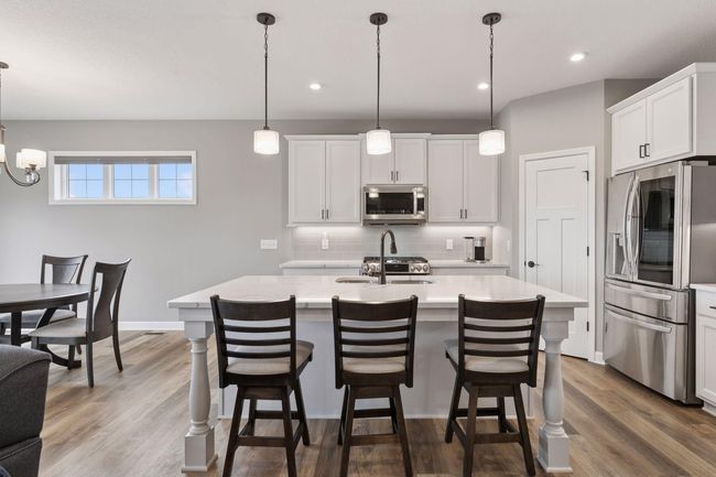 relax and grab a bite to eat at the large kitchen island | Image 11