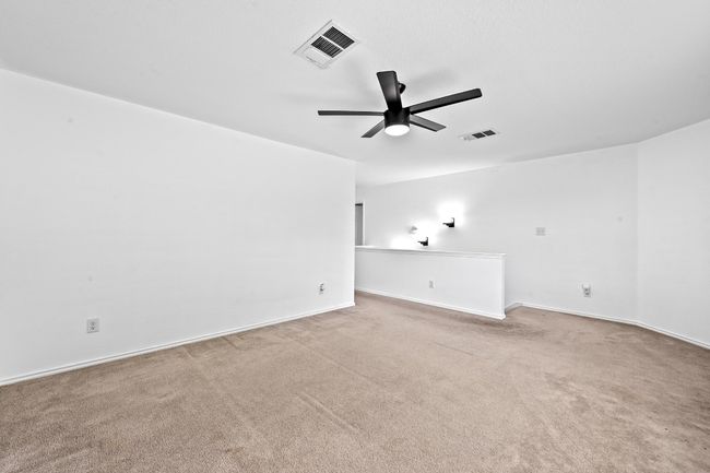 Carpeted spare room featuring a ceiling fan and baseboards | Image 22
