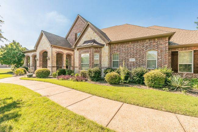 View of front of house featuring brick siding, a shingled roof, and a front lawn | Image 7