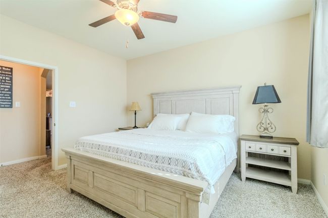 Carpeted bedroom featuring ceiling fan | Image 23