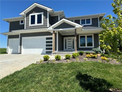 Craftsman inspired home with a garage and a front yard | Image 1